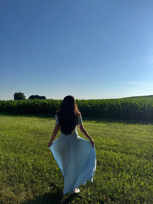 Women walking in a field holding her dress